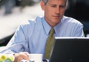 Man using laptop at cafe