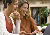 Two women, laptop, coffee shop